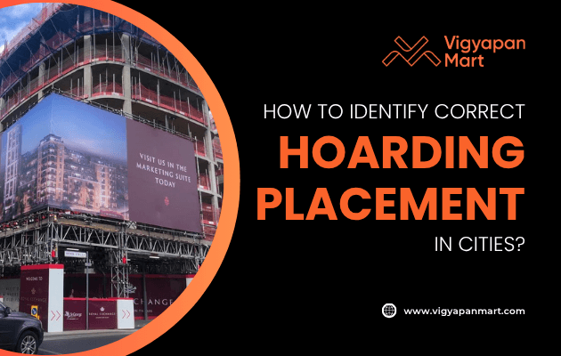 A construction site features a large marketing hoarding on its exterior. Text on the right reads, How to identify correct hoarding placement in cities? with the Vigyapan Mart logo and website.