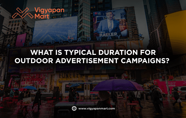 A busy city street with digital billboards and ads, overlaid with the text: What is typical duration for outdoor advertisement campaigns? and Vigyapan Mart branding.