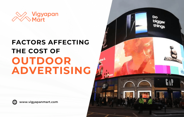 A digital billboard displays various ads above a busy city street at night. Text on the left reads: Factors Affecting the Cost of Outdoor Advertising with the Vigyapan Mart logo and website.