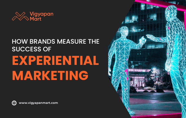 Two digital wireframe human figures interact in an urban nighttime setting. Text reads, How brands measure the success of experiential marketing. Vigyapan Mart logo and website are also visible.