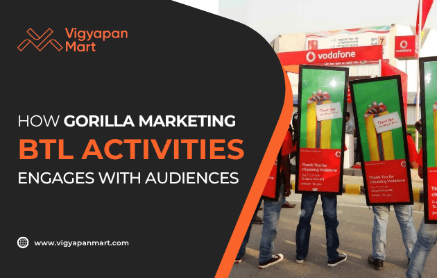 Promotional image for Vigyapan Mart showing three people wearing Vodafone advertisement boards at an event. Text reads: How Guerrilla Marketing BTL Activities Engages with Audiences. Vigyapan Mart logo and website are present.