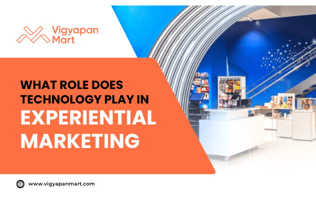 An orange and blue graphic with the Vigyapan Mart logo and the text: What role does technology play in experiential marketing. The background shows a modern retail space with display counters and a blue wall with white stars.