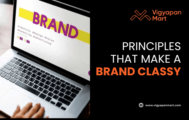 A person using a laptop displaying the word BRAND on the screen, with text on the right reading PRINCIPLES THAT MAKE A BRAND CLASSY and the Vigyapan Mart logo and website.