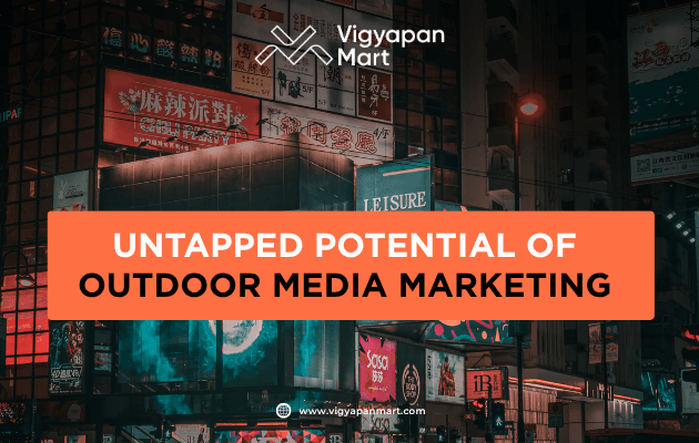 Large outdoor digital billboard displaying a vibrant advertisement on a busy city street for outdoor media marketing.