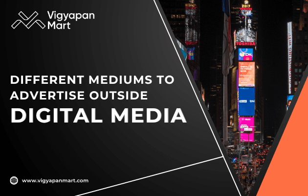 A vibrant cityscape featuring bright digital billboards, showcasing various outdoor advertising methods by Vigyapan Mart.