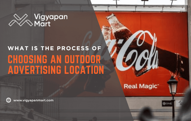 A large Coca-Cola billboard on a city street with the text, What is the process of choosing an outdoor advertising location, and Vigyapan Mart’s logo and website.