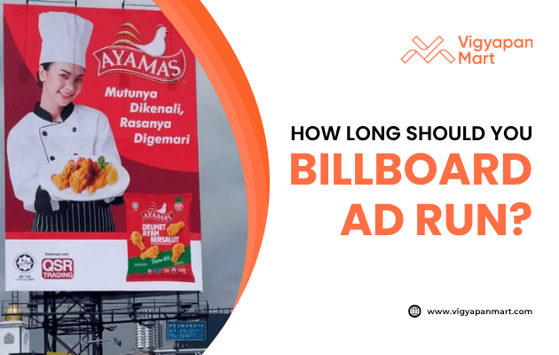 Large outdoor billboard ad for Ayamas fried chicken featuring a smiling chef holding food, with red background and product packaging. Text overlay reads “How Long Should You Billboard Ad Run?” with Vigyapan Mart branding, highlighting billboard advertising strategies.