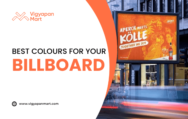 Illuminated outdoor billboard with bright orange Aperol advertisement featuring smiling people and text “Aperol meets Kölle – Together We Joy.” Overlay text reads “Best Colours for Your Billboard” with Vigyapan Mart branding, highlighting the impact of color choices in billboard advertising.