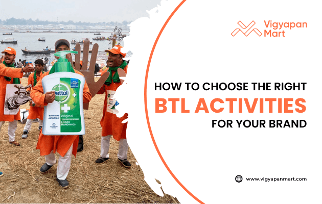 Street marketing campaign featuring promoters dressed in orange outfits holding a giant Dettol sanitizer bottle cutout during a public event. Overlay text reads “How to Choose the Right BTL Activities for Your Brand” with Vigyapan Mart branding, highlighting below-the-line marketing strategies for brand promotion.