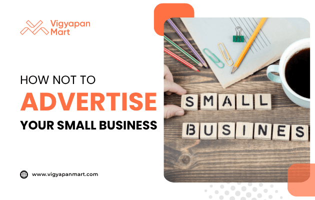 Wooden letter blocks arranged on a desk spelling “SMALL BUSINESS” with stationery items and a coffee cup nearby. Overlay text reads “How Not to Advertise Your Small Business” with Vigyapan Mart branding, focusing on common mistakes in small business advertising.