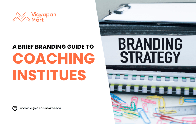 A binder labeled "Branding Strategy" placed on a desk with colorful paper clips. Overlay text reads “A Brief Branding Guide to Coaching Institutes” with Vigyapan Mart branding, highlighting marketing strategies for educational institutions.