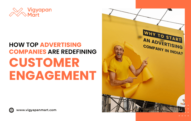 Large outdoor billboard shows a cheerful man in bright yellow clothes breaking through a yellow background. On the left, Vigyapan Mart branding with text “How Top Advertising Companies Are Redefining Customer Engagement” and website www.vigyapanmart.com