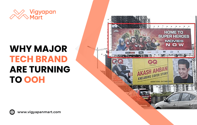 Large roadside billboards display ads including a superhero movie promotion and a GQ magazine cover story. On the left, Vigyapan Mart branding with text “Why Major Tech Brand Are Turning to OOH” and website www.vigyapanmart.com