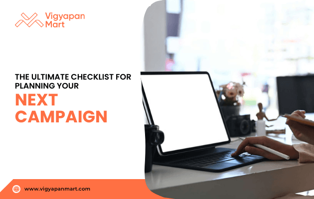 A person working on a laptop at a desk with text overlay “The Ultimate Checklist for Planning Your Next Campaign” alongside Vigyapan Mart branding and website www.vigyapanmart.com