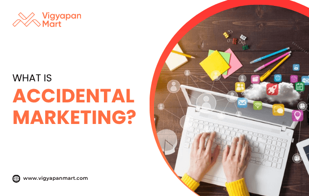 Person typing on a laptop with digital marketing icons floating above, featured by Vigyapan Mart with text “What is Accidental Marketing?