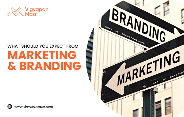 Street signboards labeled "Branding" and "Marketing" against a city background, with Vigyapan Mart branding and text “What should you expect from Marketing & Branding.