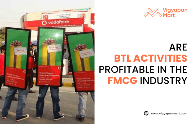 Vigyapan Mart graphic asking if BTL activities are profitable in the FMCG industry, featuring Vodafone brand promoters wearing large advertising boards with promotional messages during a street marketing campaign.