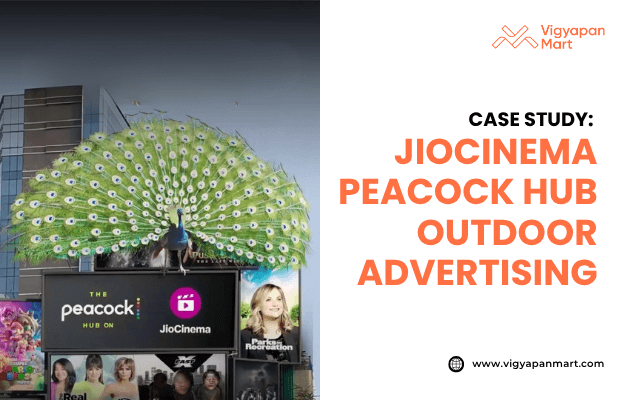 Vigyapan Mart graphic showcasing JioCinema Peacock Hub outdoor advertising with a giant 3D peacock installation above digital billboards displaying JioCinema and The Peacock Hub branding. Right side text reads “Case Study: JioCinema Peacock Hub Outdoor Advertising.” Vigyapan Mart logo and website are shown.