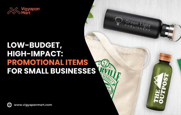 Promotional products for small businesses showing branded merchandise including custom water bottles and eco-friendly tote bag with printed logos. Marketing banner highlights text 'Low-Budget, High-Impact: Promotional Items for Small Businesses' by Vigyapan Mart, ideal for cost-effective brand promotion.