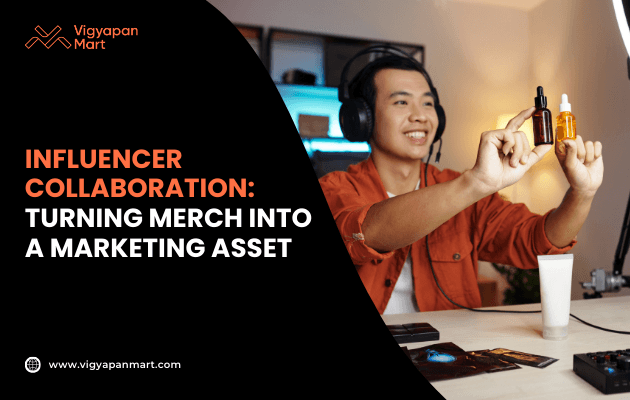 Smiling young man wearing headphones and orange jacket livestreaming at desk with gaming setup, representing influencer marketing. Banner text reads 'Influencer Collaboration: Turning Merch into a Marketing Asset' by Vigyapan Mart, emphasizing promotional merchandise in influencer partnerships.