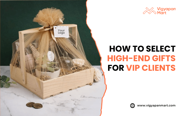 Luxury wooden gift hamper wrapped in golden net with bow, containing premium items and placeholder for custom logo, placed on marble surface. Marketing banner text reads 'How to Select High-End Gifts for VIP Clients' by Vigyapan Mart, emphasizing exclusive corporate gifting solutions.