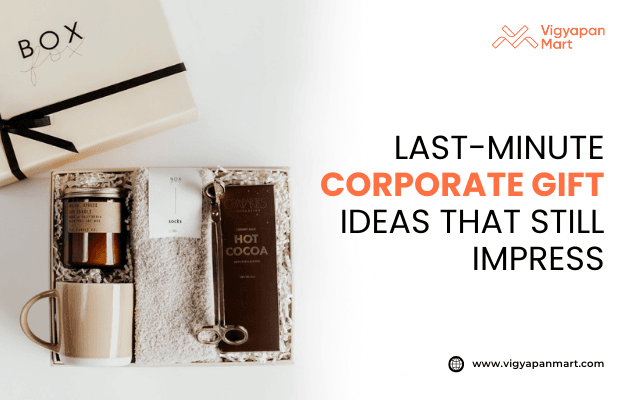 Elegant last-minute corporate gift box including scented candle, ceramic mug, socks, hot cocoa mix, and towel, neatly arranged in a luxury package. Marketing banner text reads 'Last-Minute Corporate Gift Ideas That Still Impress' by Vigyapan Mart, showcasing thoughtful business gifting options.