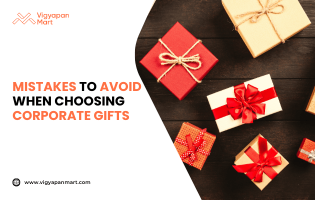 Collection of beautifully wrapped corporate gifts in red and beige boxes with decorative ribbons, arranged on dark wooden surface. Marketing banner text reads 'Mistakes to Avoid When Choosing Corporate Gifts' by Vigyapan Mart, highlighting tips for effective business gifting.