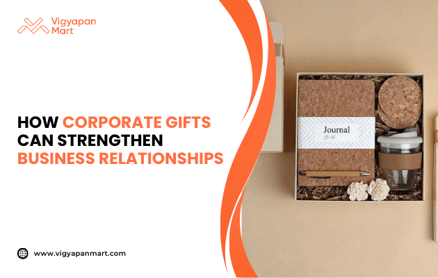 Eco-friendly corporate gift box containing cork-covered journal, reusable coffee cup, coasters, and decorative flowers, neatly packed in sustainable packaging. Marketing banner text reads 'How Corporate Gifts Can Strengthen Business Relationships' by Vigyapan Mart, highlighting gifting as a strategy for client and employee engagement.