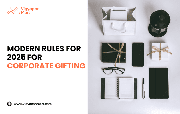 Flat lay of modern corporate gifts including wrapped boxes with gold ribbons, notebook, pen, smartphone, eyeglasses, and tablet, alongside text 'Modern Rules for 2025 for Corporate Gifting' by Vigyapan Mart, highlighting business gift trends, professional gifting etiquette, and corporate culture.
