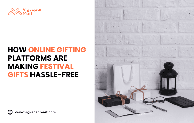 Flat lay of corporate festival gifts including black and white wrapped boxes, shopping bag, notebook, pen, eyeglasses, and lantern on a desk, with text 'How Online Gifting Platforms Are Making Festival Gifts Hassle-Free' by Vigyapan Mart, emphasizing digital gifting solutions, convenience, and modern corporate gift trends.
