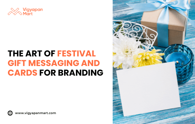 Blank greeting card placed beside a gift box with blue ribbon, white and yellow flowers, and a blue candle on a wooden table, with text: The art of festival gift messaging and cards for branding. Vigyapan Mart branding and website shown.