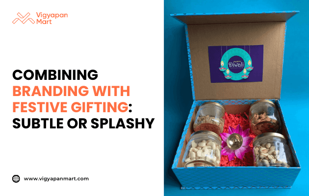 Festive gift box with jars of dry fruits and a decorative diya, arranged in colorful packaging with 'Happy Diwali' branding inside the lid, alongside text: Combining branding with festive gifting: Subtle or splashy. Vigyapan Mart branding and website shown.