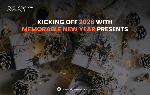Wrapped New Year gifts decorated with pinecones, golden ribbons, and festive ornaments, overlaid with text “Kicking Off 2026 with Memorable New Year Presents,” featuring Vigyapan Mart logo and website.