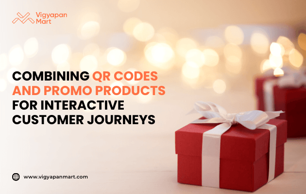 Red gift box with white ribbon on a blurred festive light background, alongside text “Combining QR Codes and Promo Products for Interactive Customer Journeys,” with Vigyapan Mart logo and website.