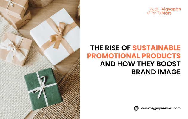 Eco-friendly gift boxes wrapped in white, brown, and green paper with ribbons on a woven surface, beside text “The Rise of Sustainable Promotional Products and How They Boost Brand Image,” featuring Vigyapan Mart logo and website.