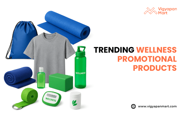 Assorted wellness promotional products including yoga mats, t-shirt, gym bag, water bottle, sanitizer, resistance band, pill box, stress ball, pedometer, and supplement container with text “Trending Wellness Promotional Products” and Vigyapan Mart branding.