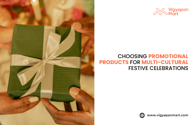 Hands exchanging a green gift box with a white satin ribbon, symbolizing festive gift-giving. Text reads "Choosing Promotional Products for Multi-Cultural Festive Celebrations," with keywords in red. Vigyapan Mart logo appears top right, website www.vigyapanmart.com bottom right. Promotes gift ideas for diverse cultural celebrations.
