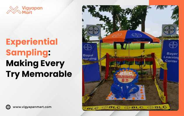 Colorful outdoor display at Bayer Learning Center with vibrant banners, umbrellas, and a decorative centerpiece, promoting experiential sampling.