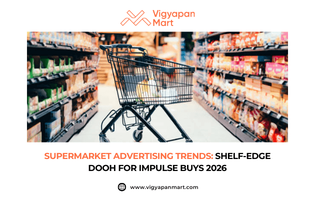 Shopping cart positioned in a supermarket aisle with colorful products, featuring the text “Supermarket Advertising Trends: Shelf-Edge DOOH for Impulse Buys 2026.”