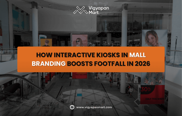 Mall interior showcasing interactive kiosks and fashion advertisements, with a bold orange banner reading “How Interactive Kiosks in Mall Branding Boosts Footfall in 2026”