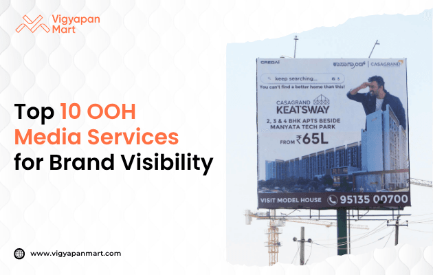 A billboard promoting Casagrand apartments is displayed beside Manyata Tech Park, highlighting top OOH media services for brand visibility, with contact information visible.