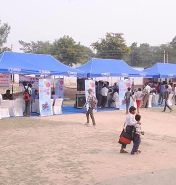 Branded helium advertising balloon showcasing advertising in rural areas at an Indian haat market.