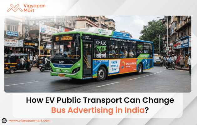 Electric bus advertising in India showing branded EV bus on a city road